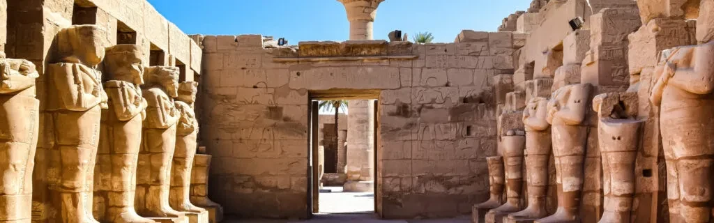 Visitors walking through Luxor Temple discovering hieroglyphs